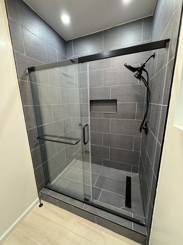 Finished tiled shower with glass enclosure